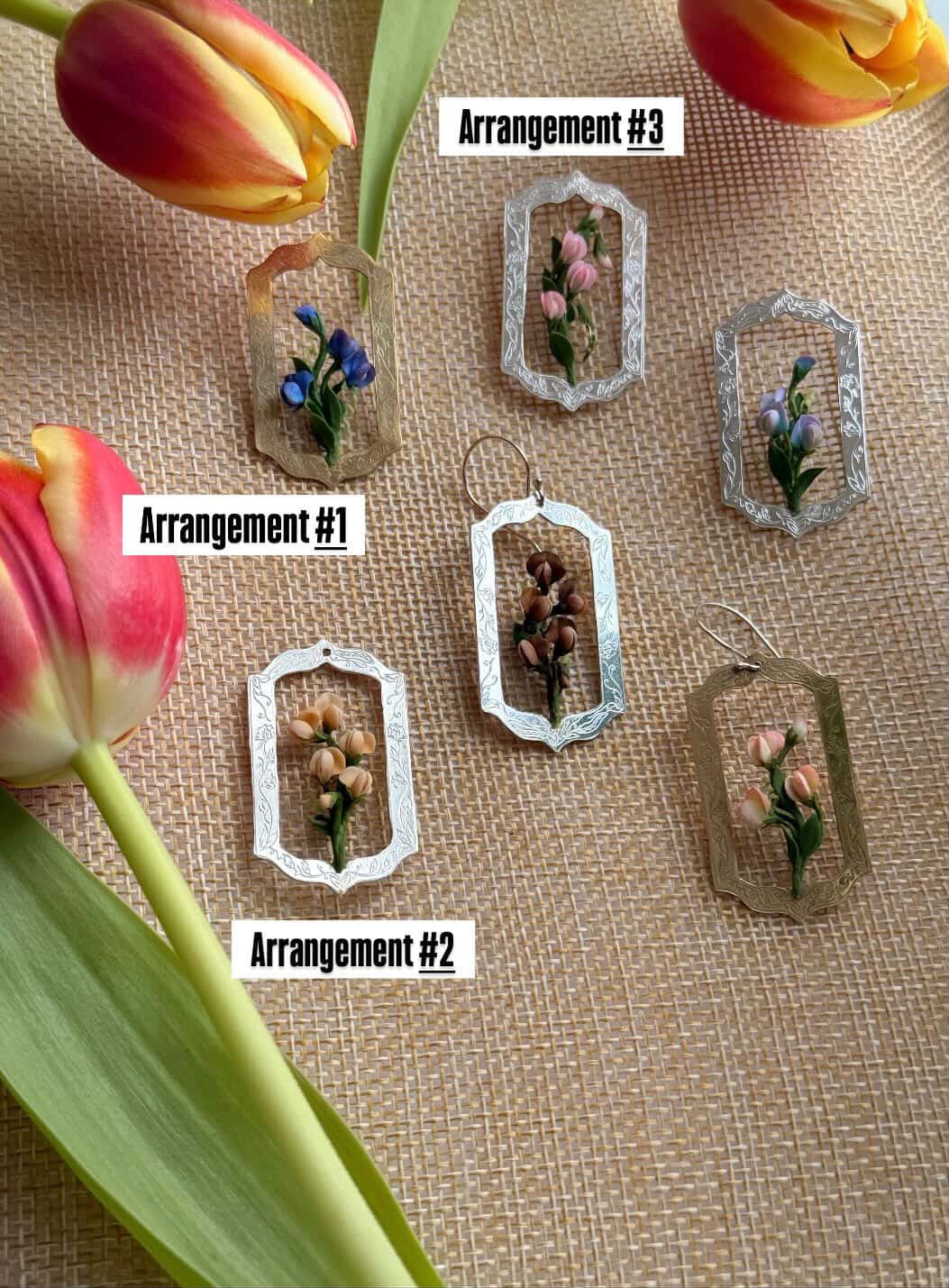 Decorative frames with floral arrangements on a textured surface